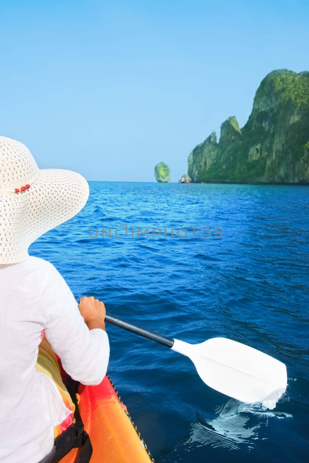 Young woman is kayaking in tropical lagoon