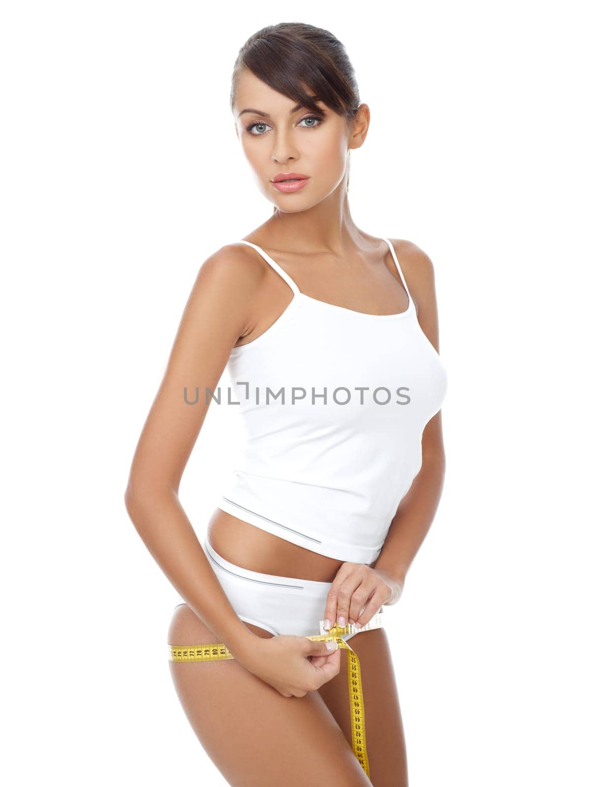 Young beautiful woman with measure tape on white