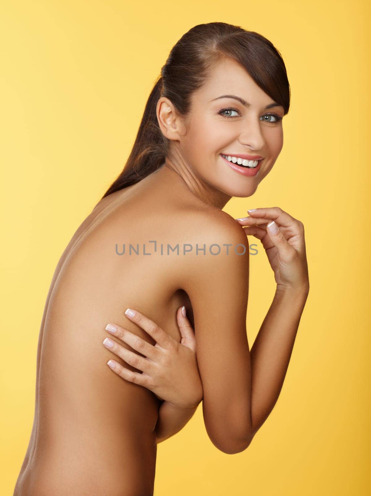 Portrait of beautiful and sexy woman on yellow