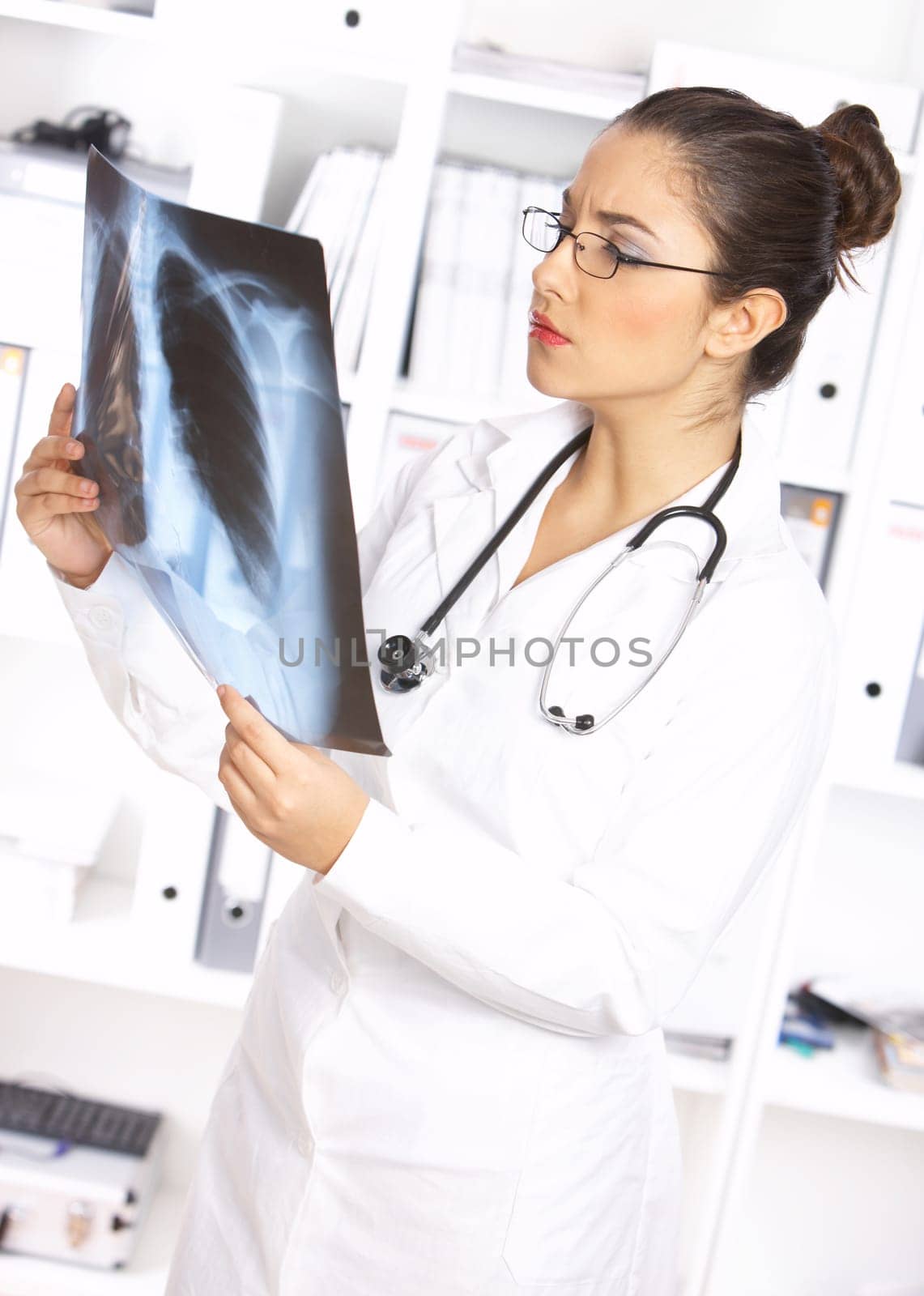 Portrait of female doctor examining x-ray picture