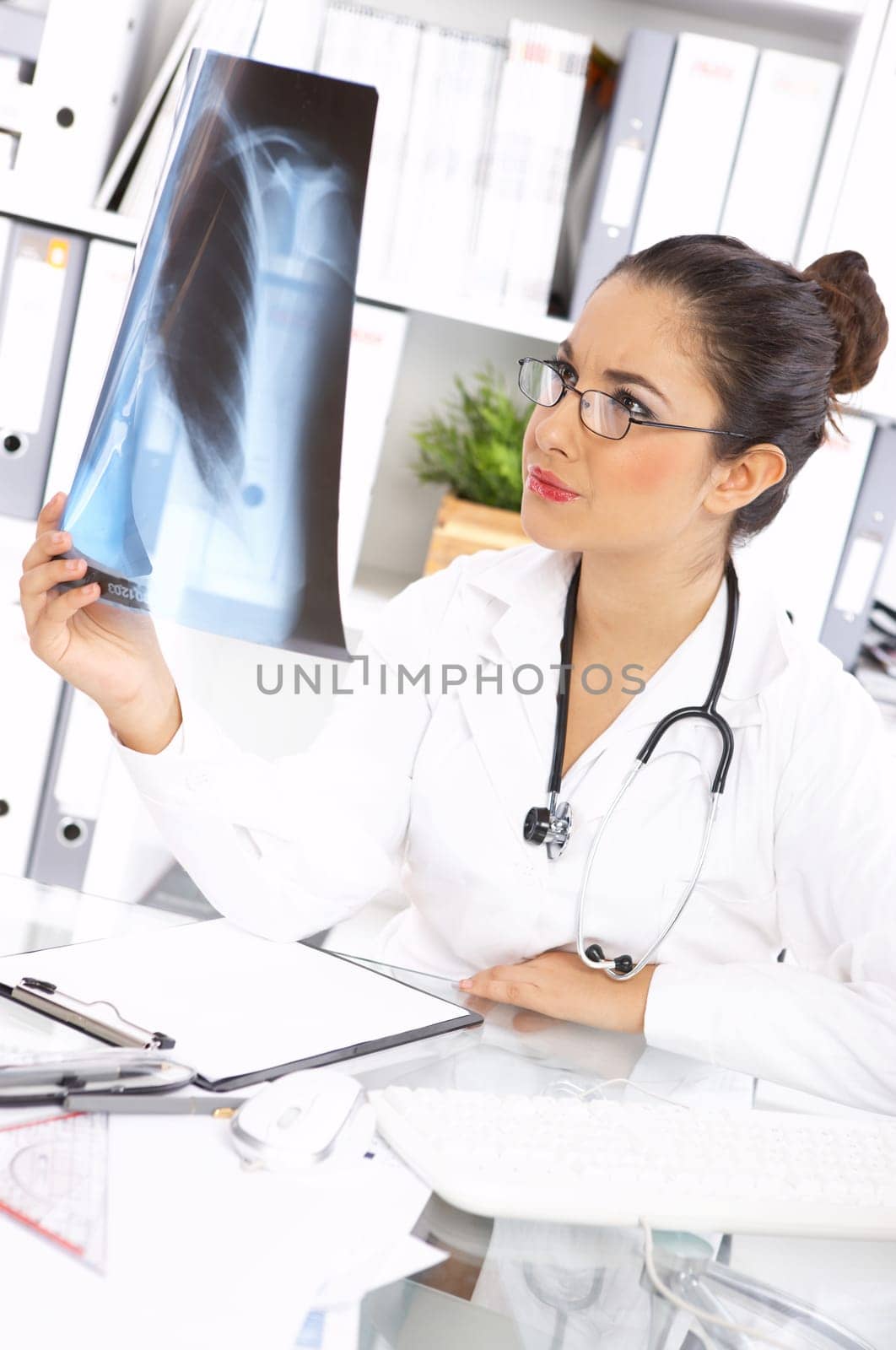 Portrait of female doctor examining x-ray picture