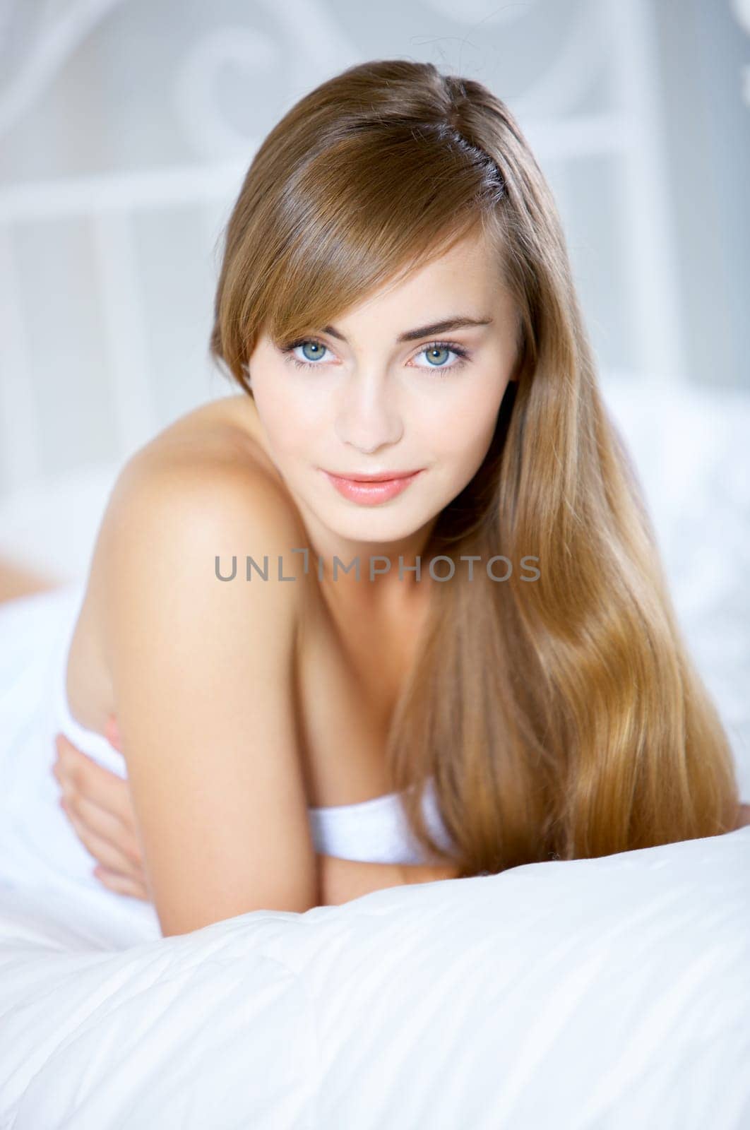 Beautiful teenager on white bed at her home