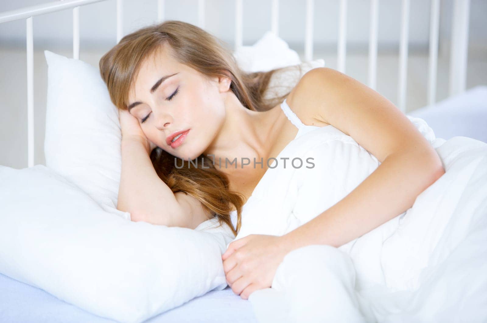 Beautiful teenager on white bed at her home