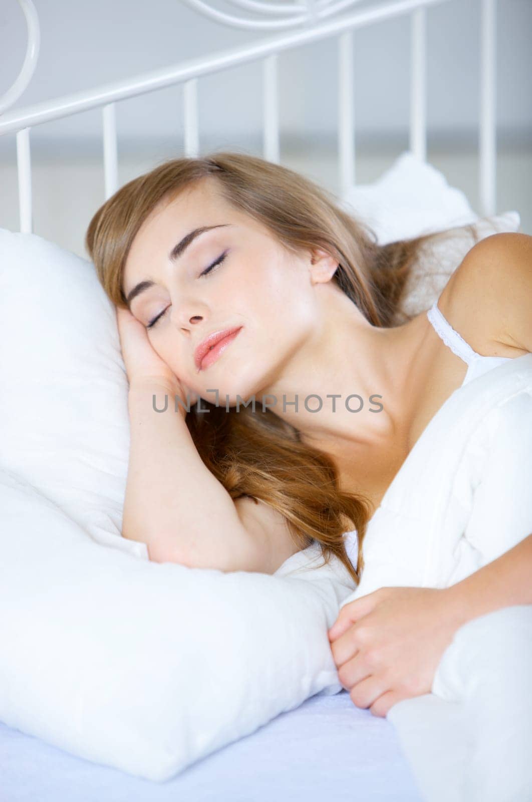 Beautiful teenager on white bed at her home