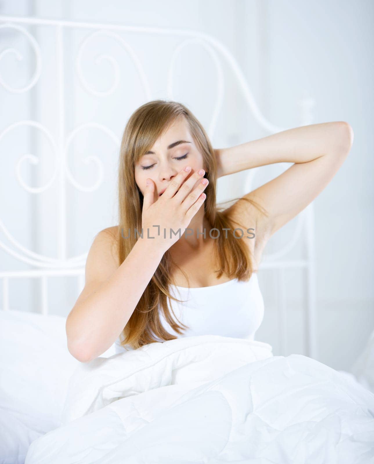 Beautiful teenager on white bed at her home