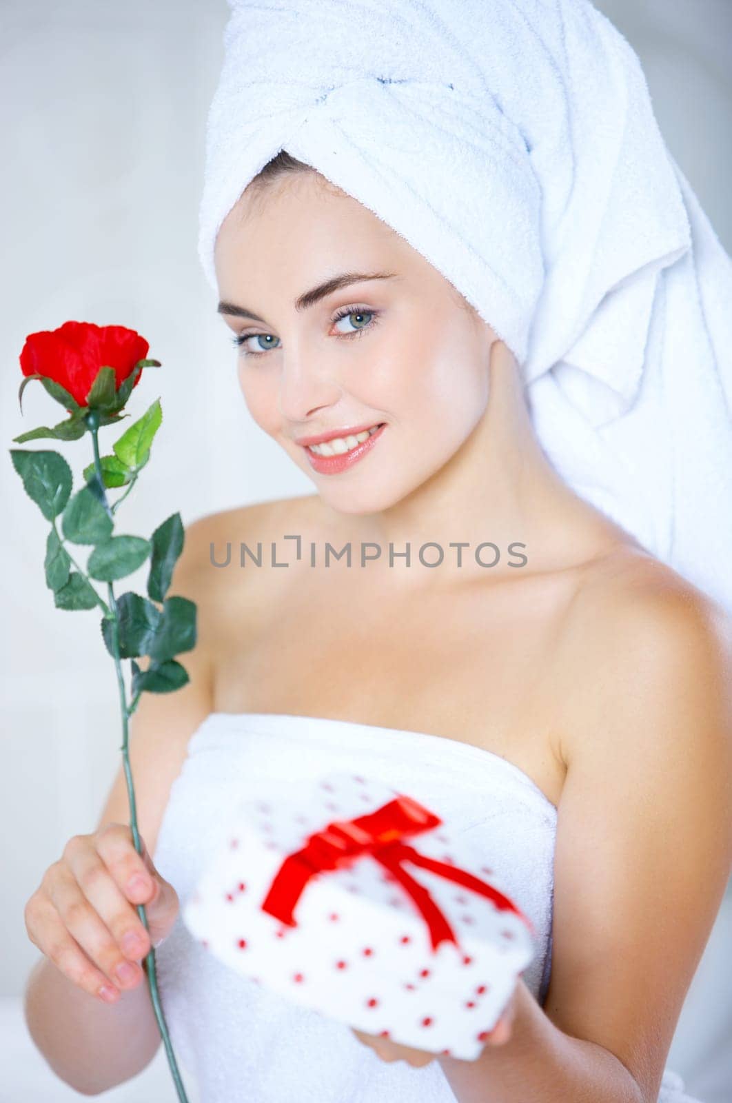 Portrait of cute teenage girl with heart shaped box and rose