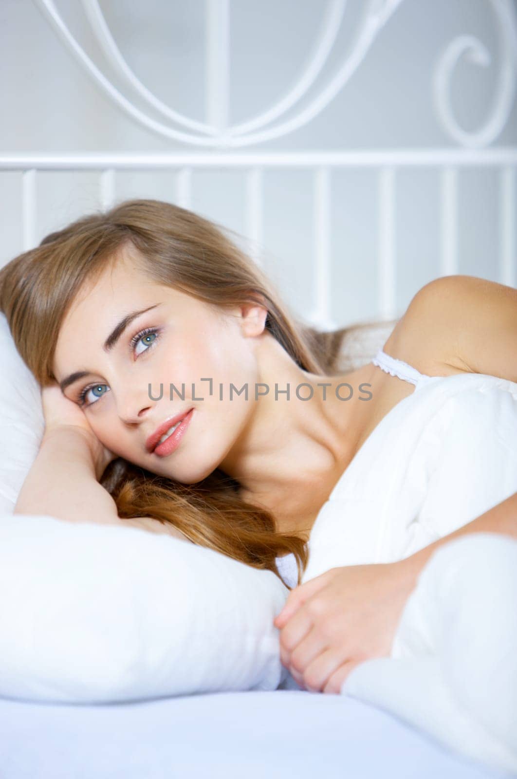 Beautiful teenager on white bed at her home