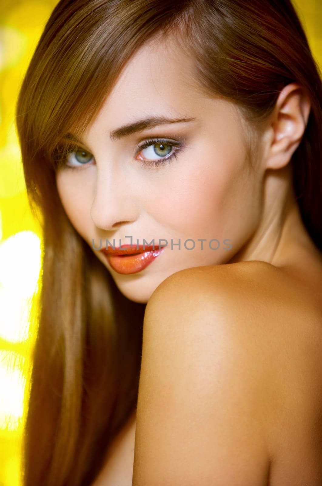 Portrait of beautiful young sexy woman on yellow background