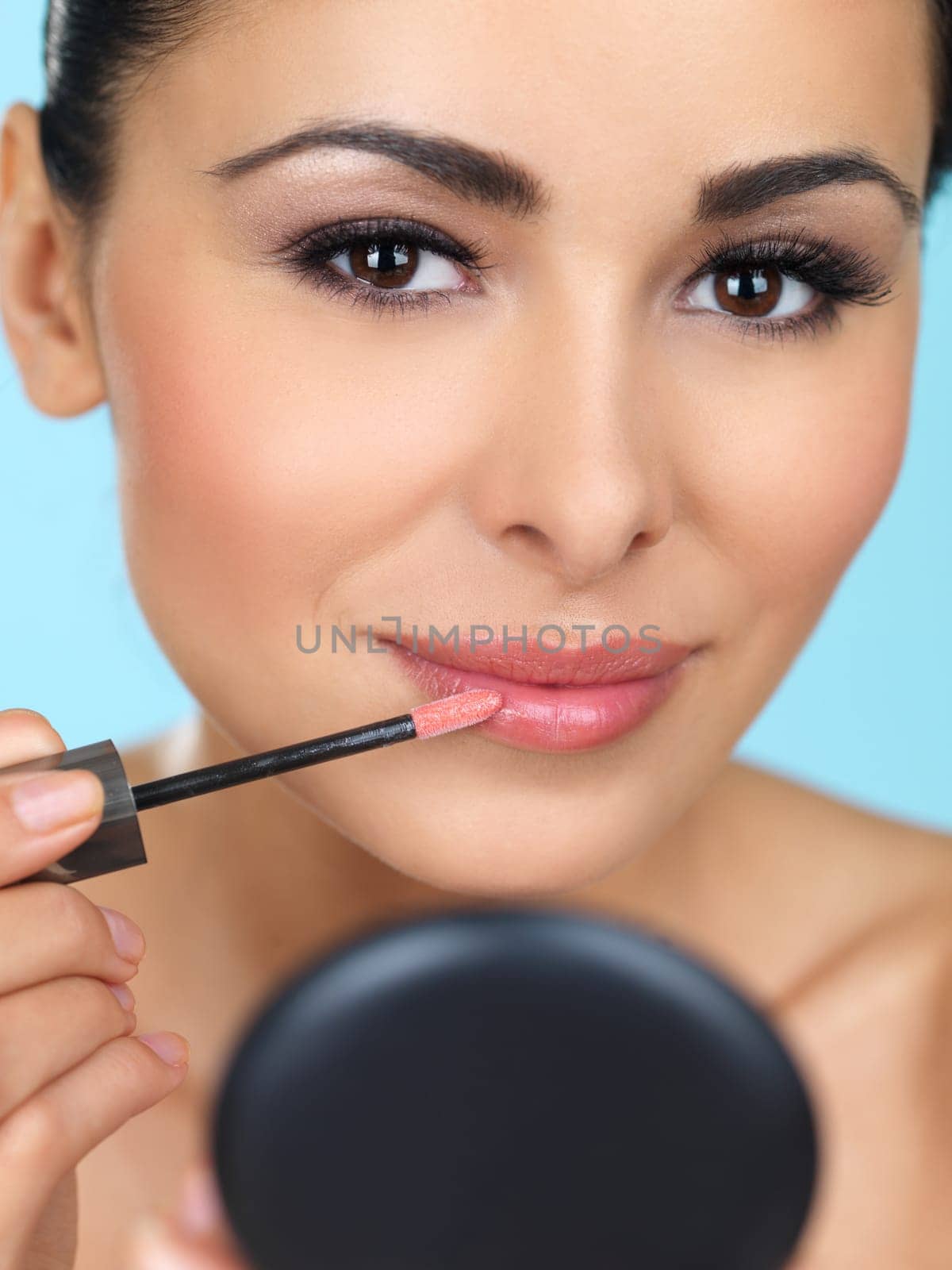 Portrait of beautiful woman she is doing makeup
