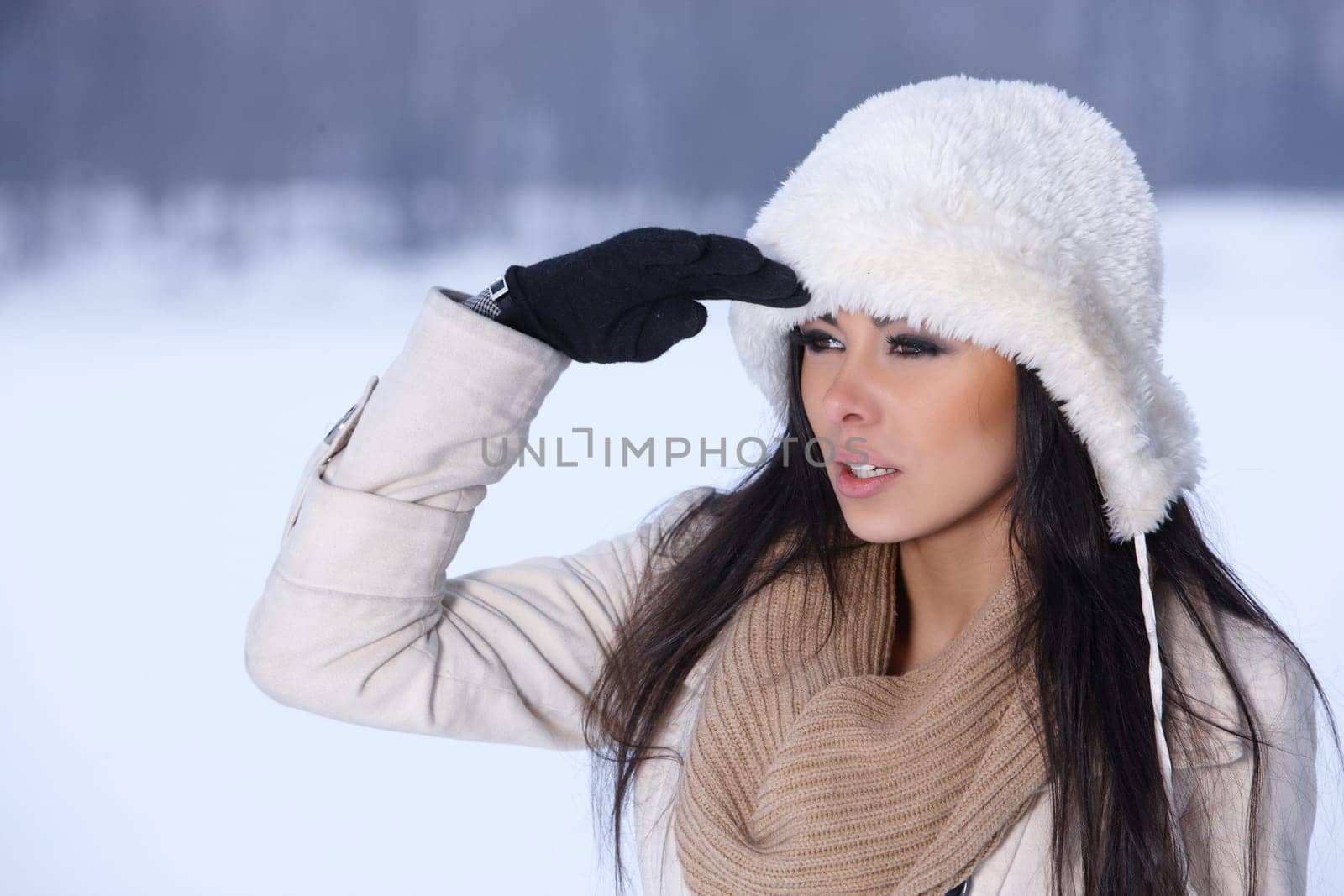Beautiful and sexy woman in snowy winter outdoors