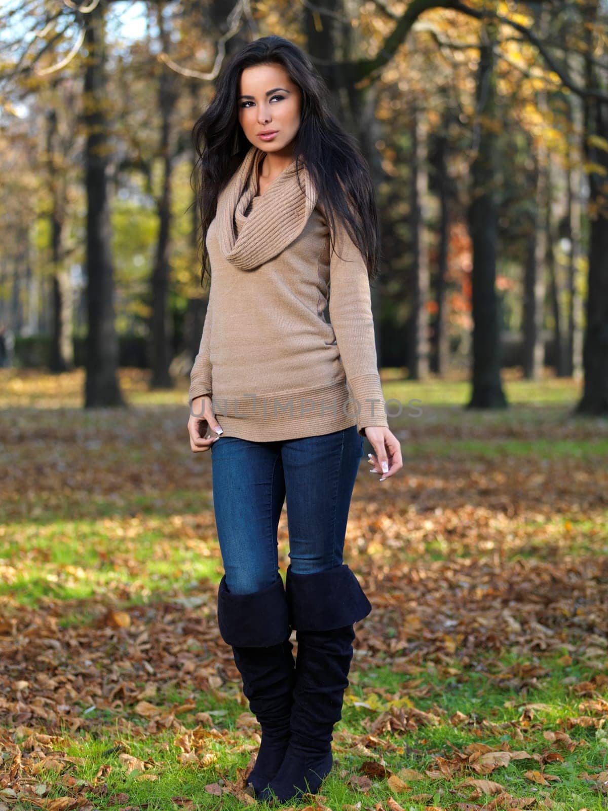 Beautiful woman spending time in park during autumn season