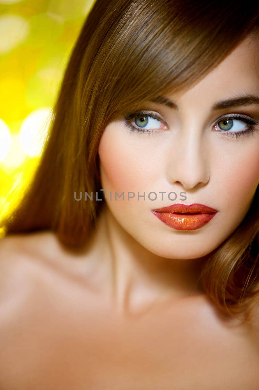 Portrait of beautiful young sexy woman on yellow background