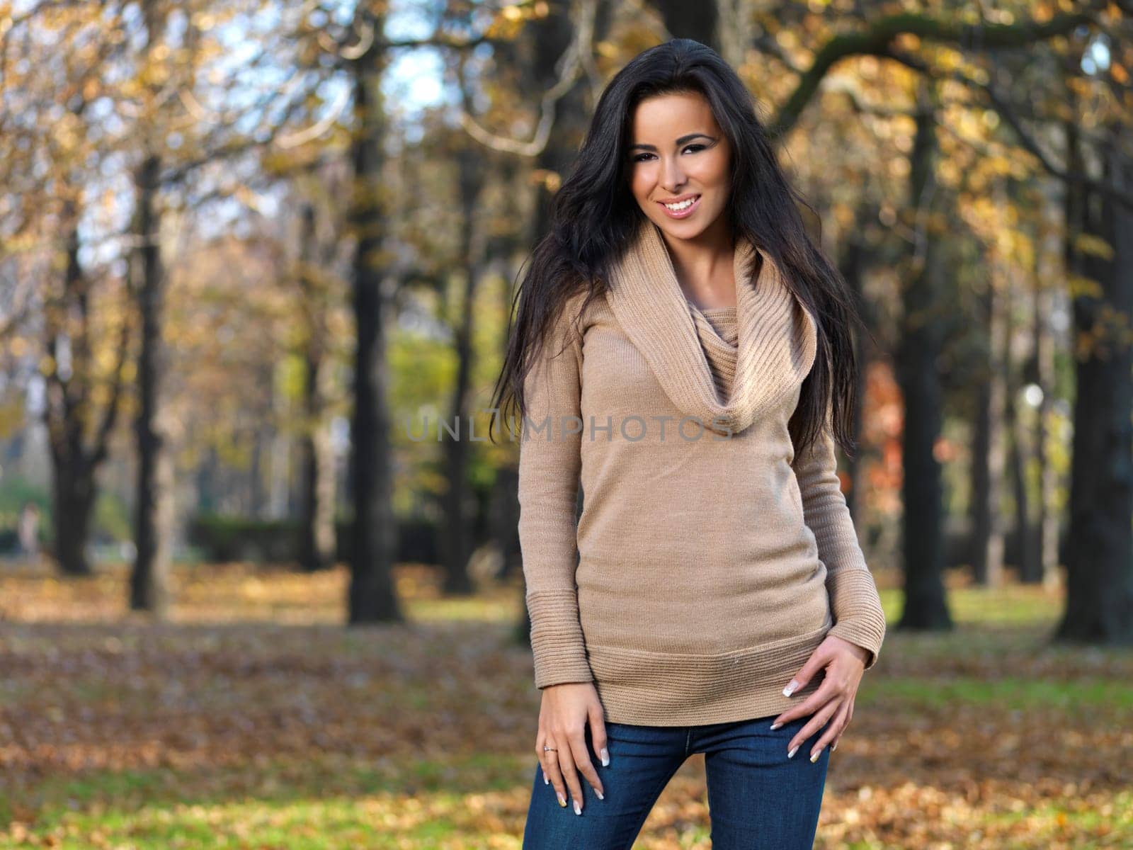 Beautiful woman spending time in park during autumn season