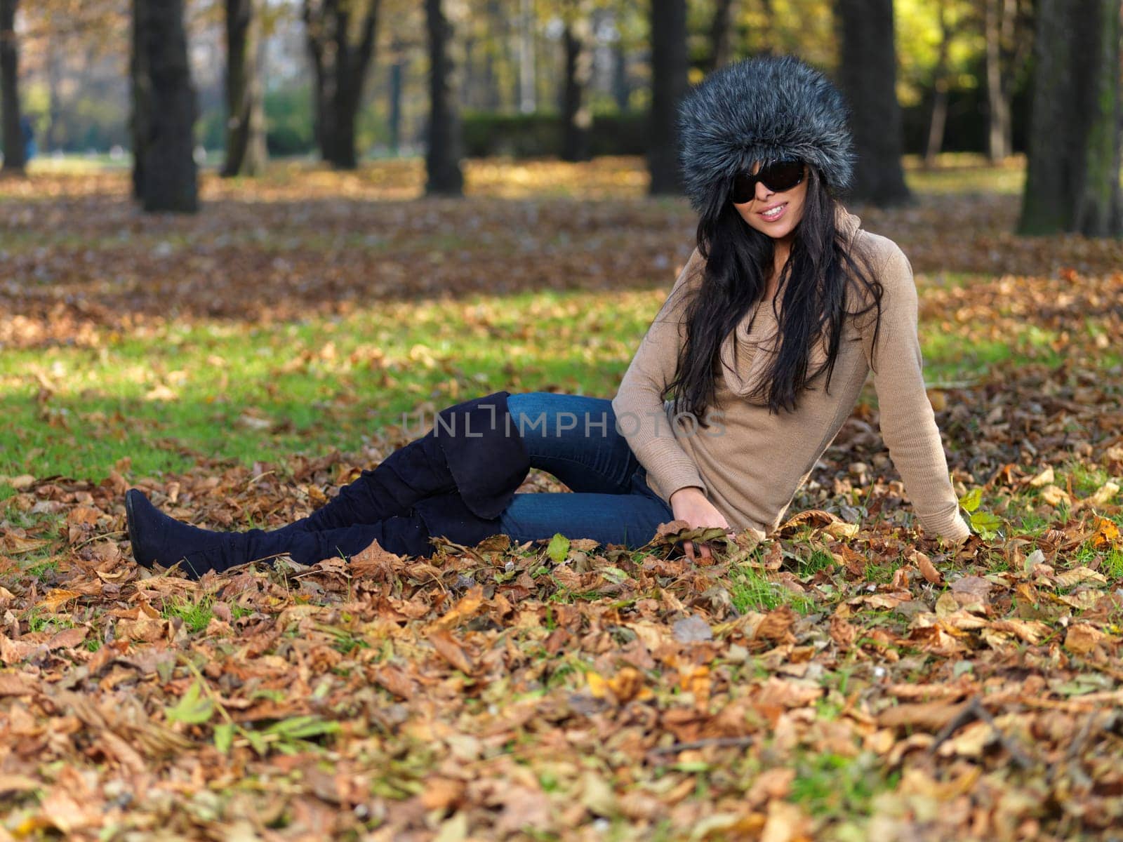 Beautiful woman spending time in park during autumn season