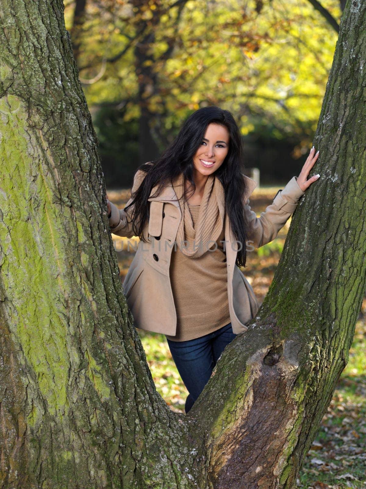 Beautiful woman spending time in park during autumn season