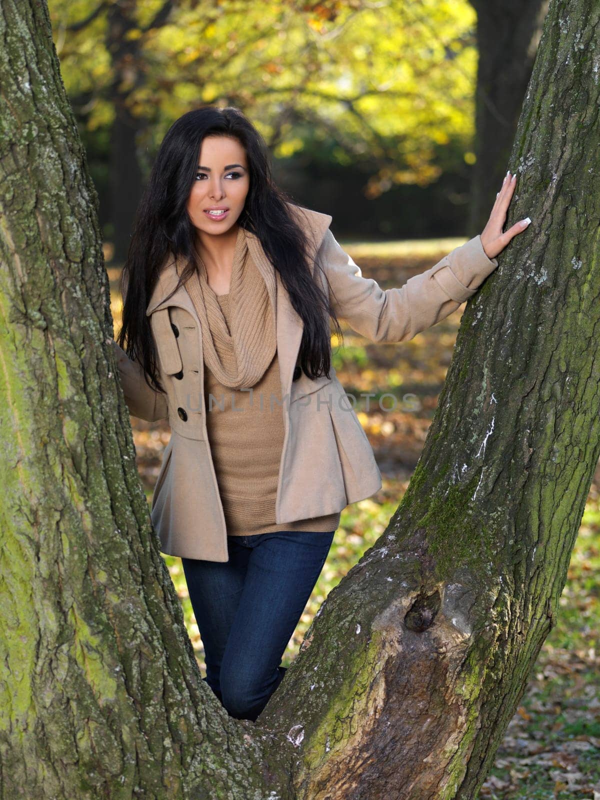 Beautiful woman spending time in park during autumn season