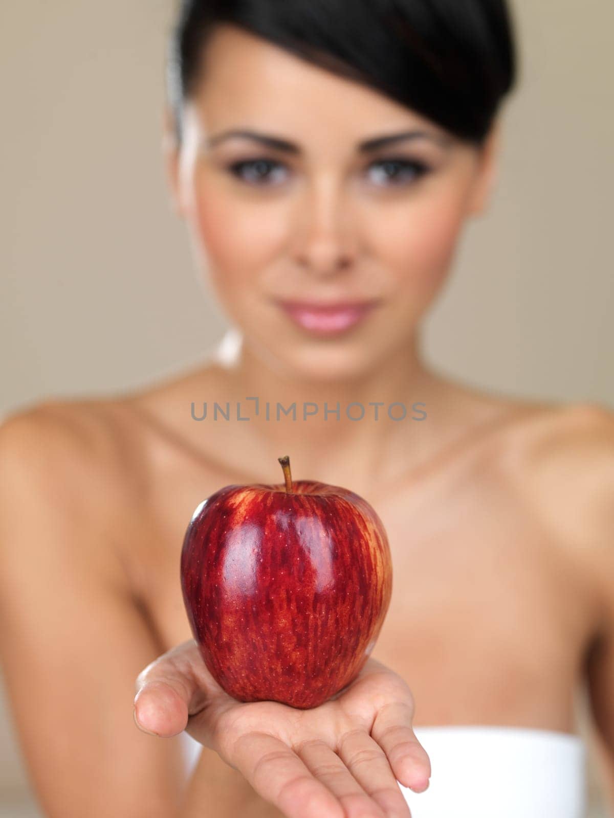 Portrait of beautiful woman, she holding red apple