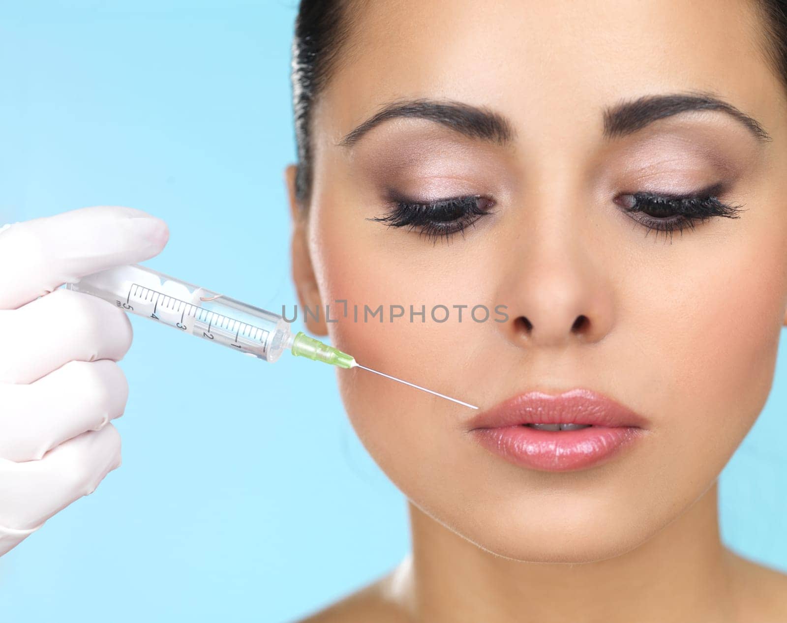 Beautiful woman gets botox injection in her face