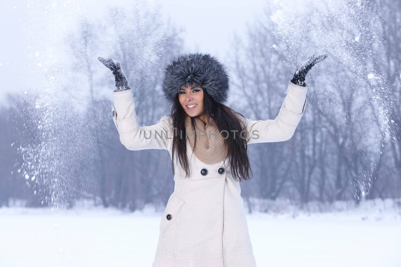 Beautiful and sexy woman in snowy winter outdoors