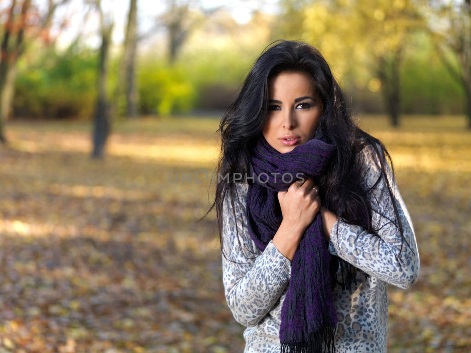 Beautiful woman spending time in park during autumn season