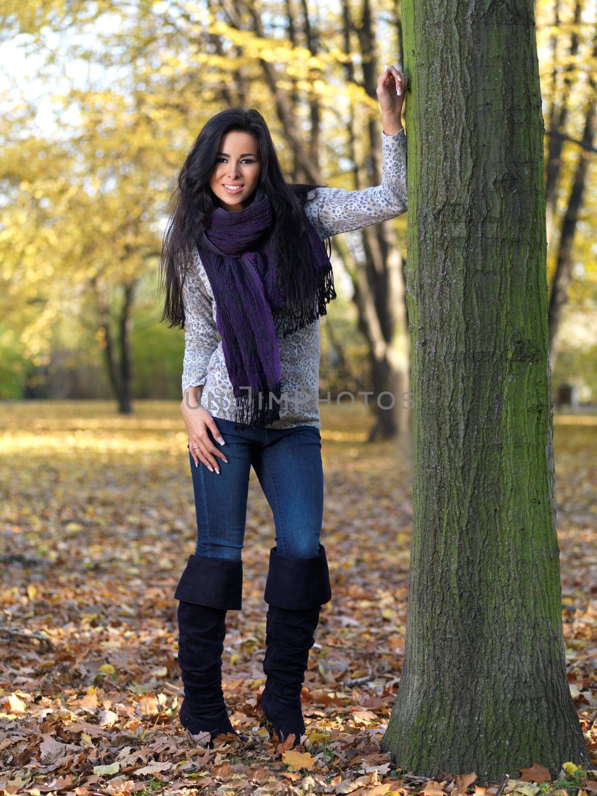 Beautiful woman spending time in park during autumn season