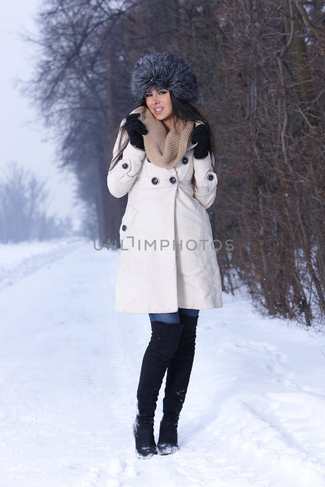 Beautiful and sexy woman in snowy winter outdoors