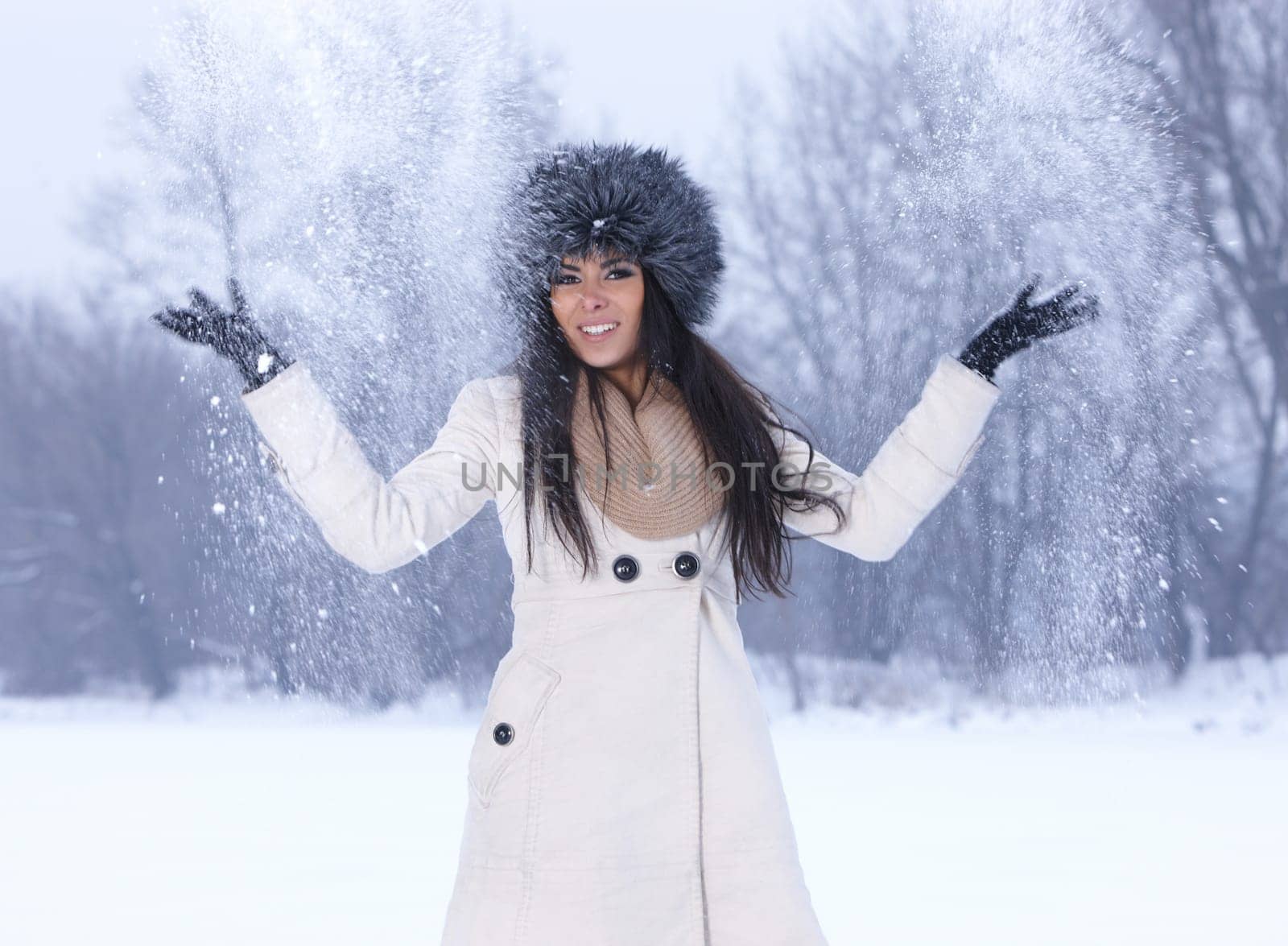 Beautiful and sexy woman in snowy winter outdoors