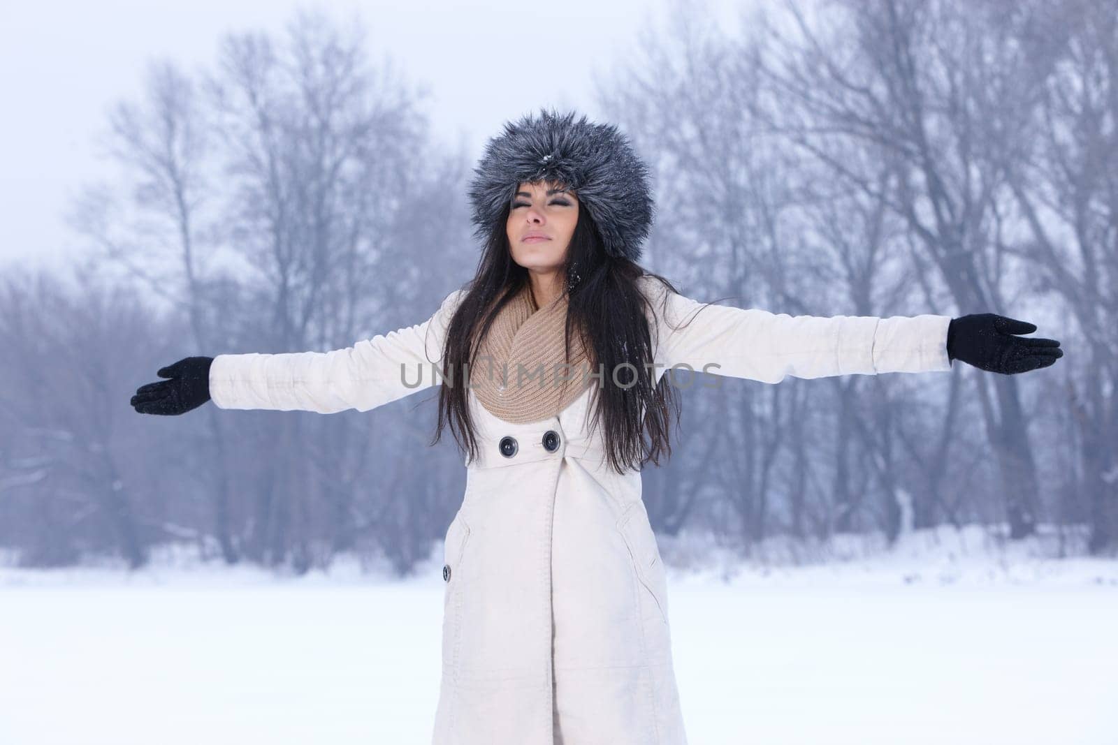 Beautiful and sexy woman in snowy winter outdoors