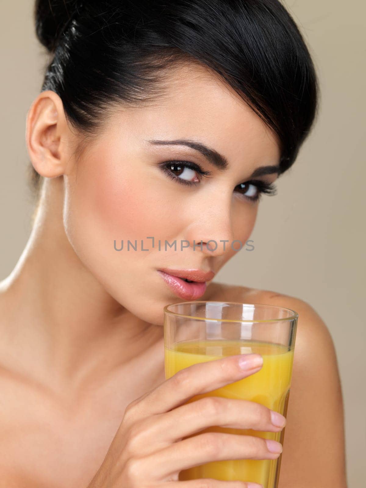 Portrait of beautiful woman, she holding glass of orange juice