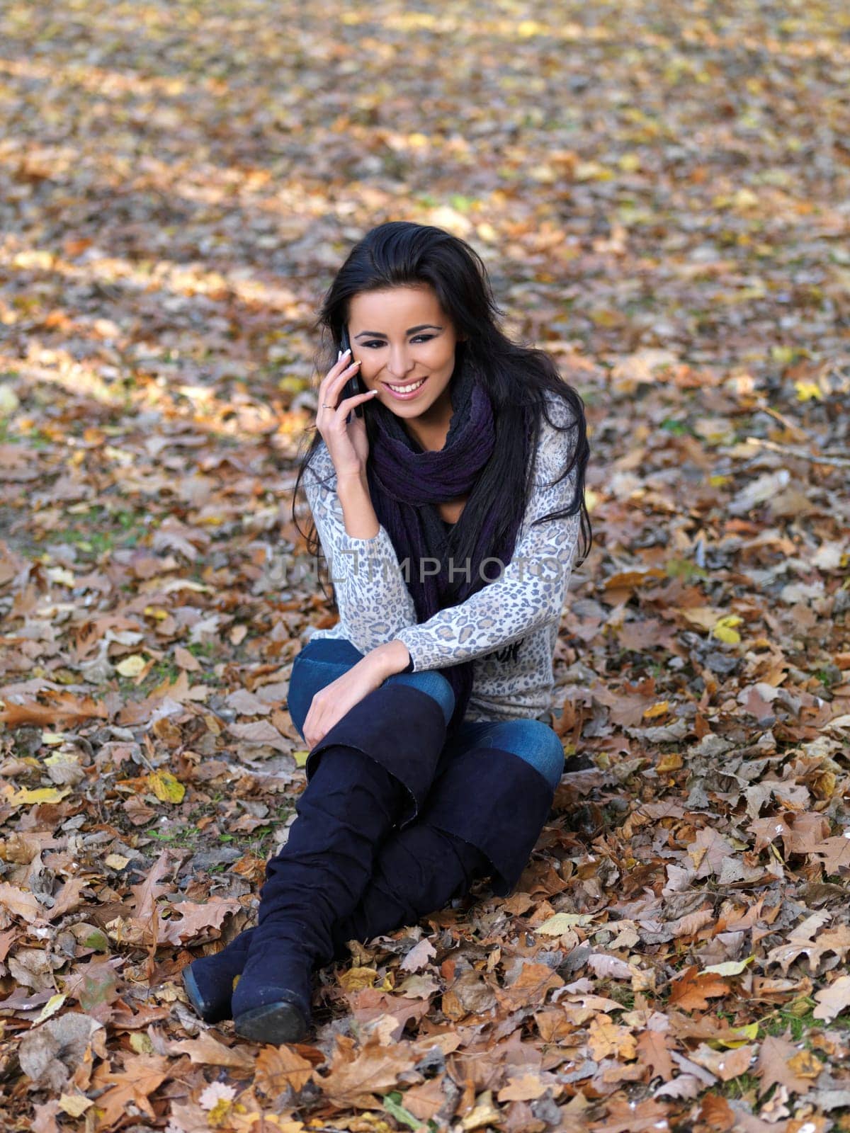 Beautiful woman spending time in park during autumn season