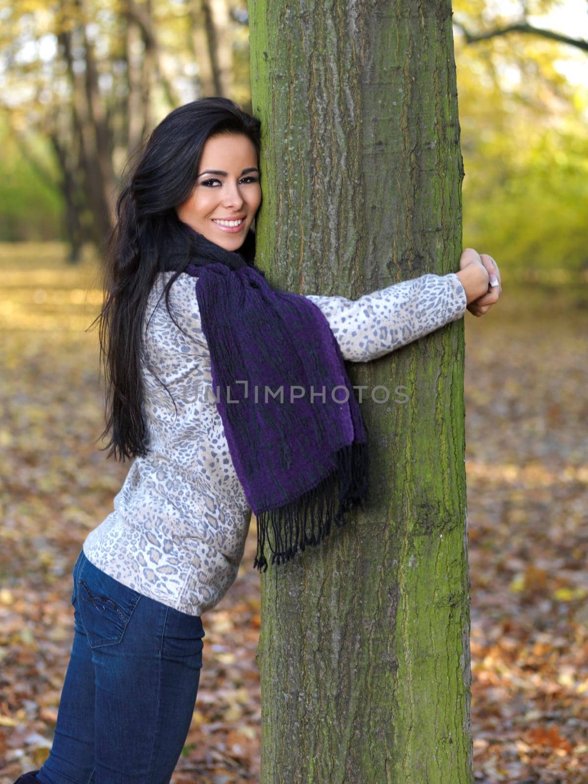 Beautiful woman spending time in park during autumn season