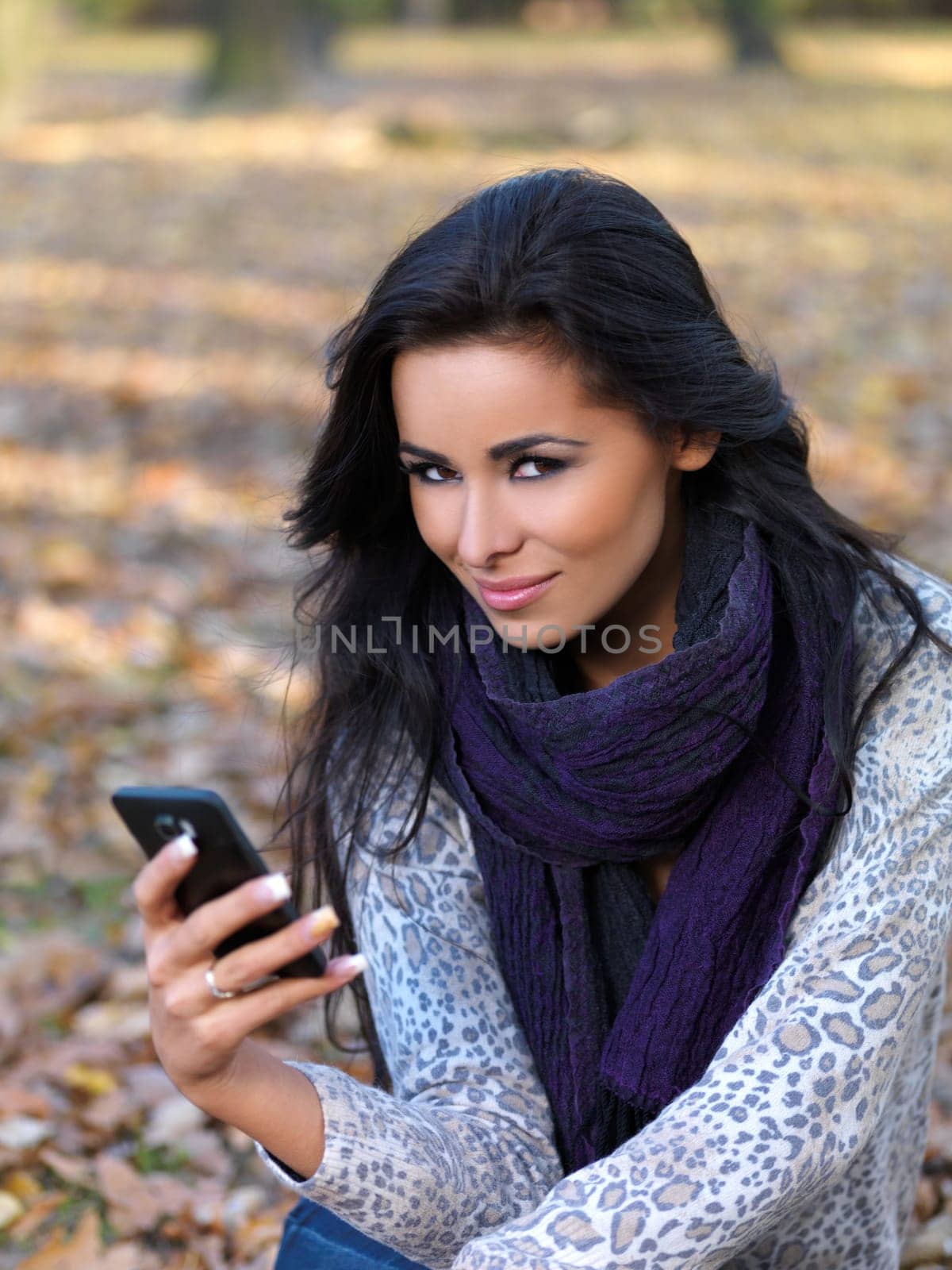 Beautiful woman spending time in park during autumn season