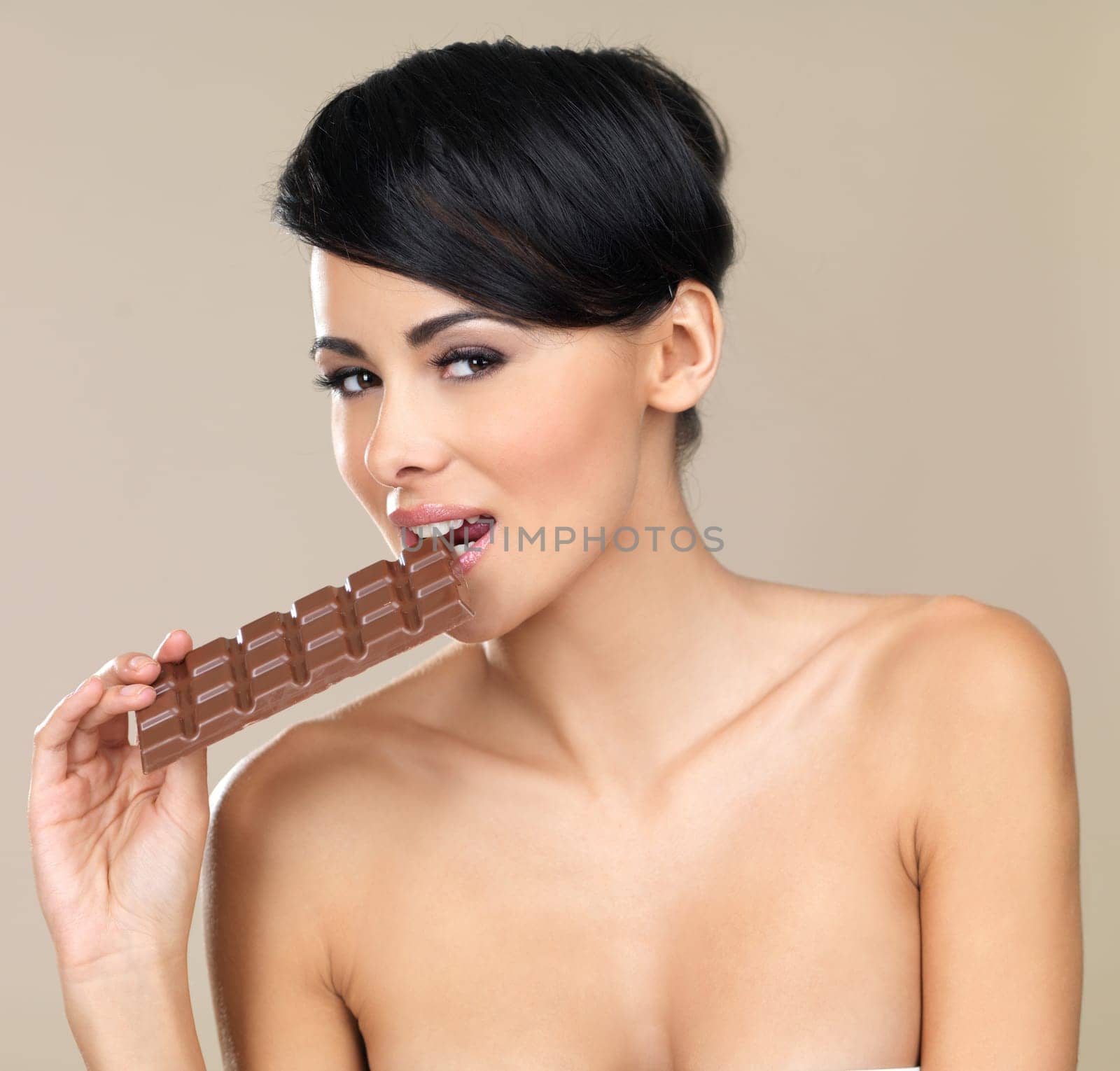Portrait of beautiful woman, she holding chocolate bar