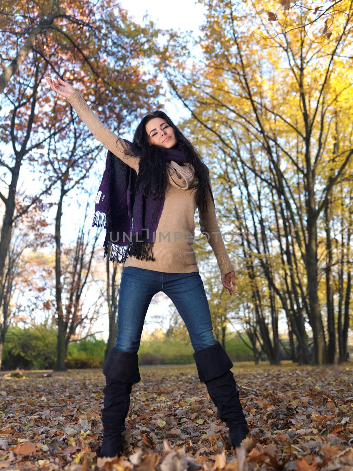 Beautiful woman spending time in park during autumn season