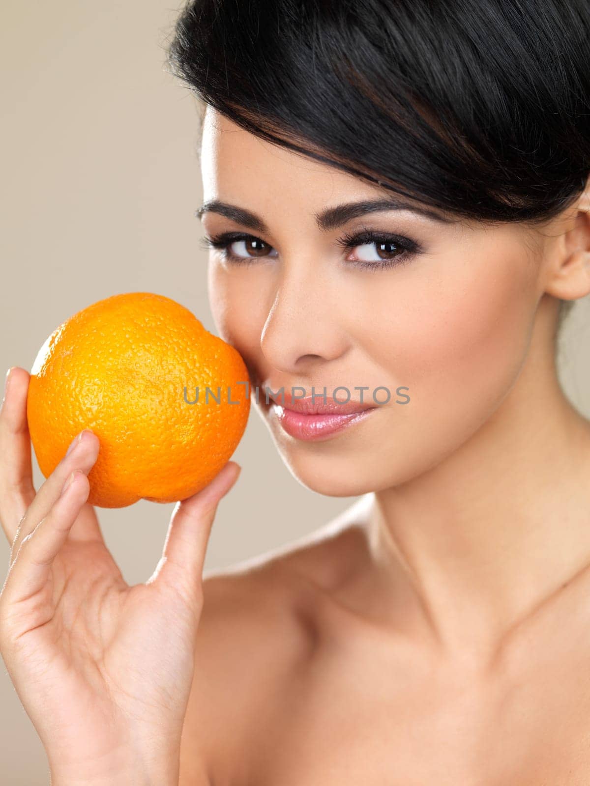 Portrait of beautiful woman, she holding fresh orange