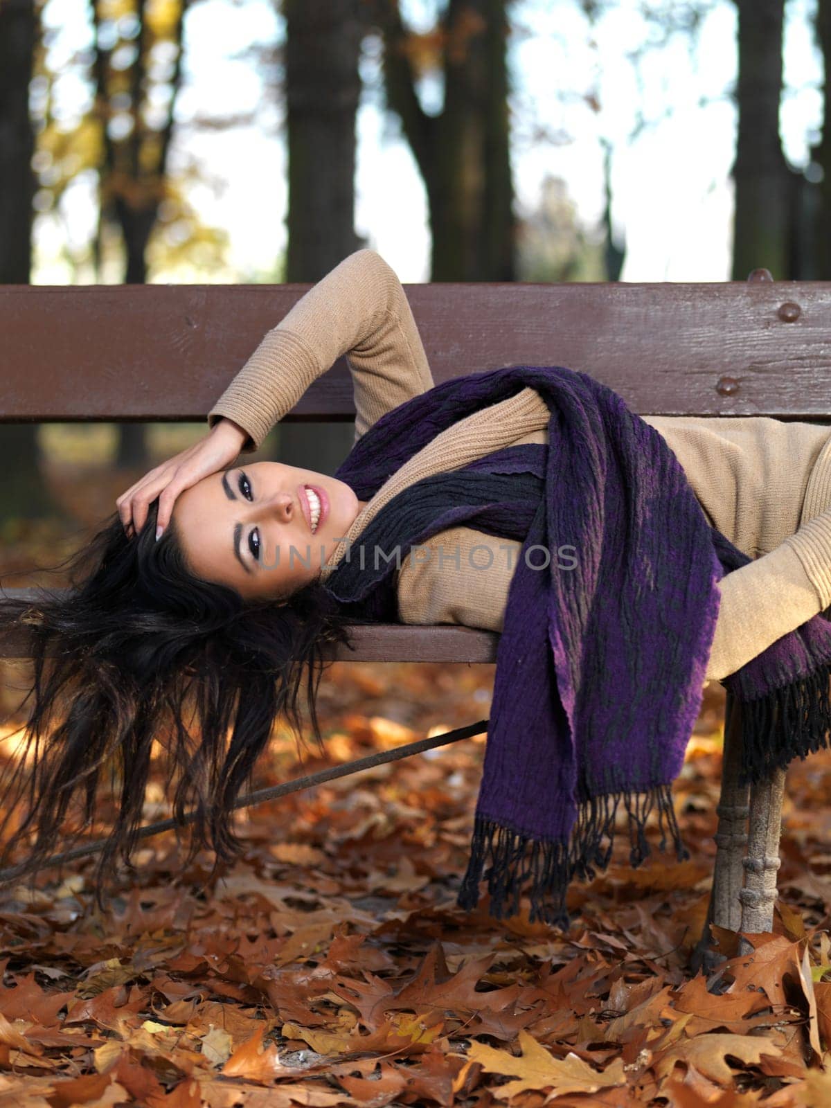 Beautiful woman spending time in park during autumn season