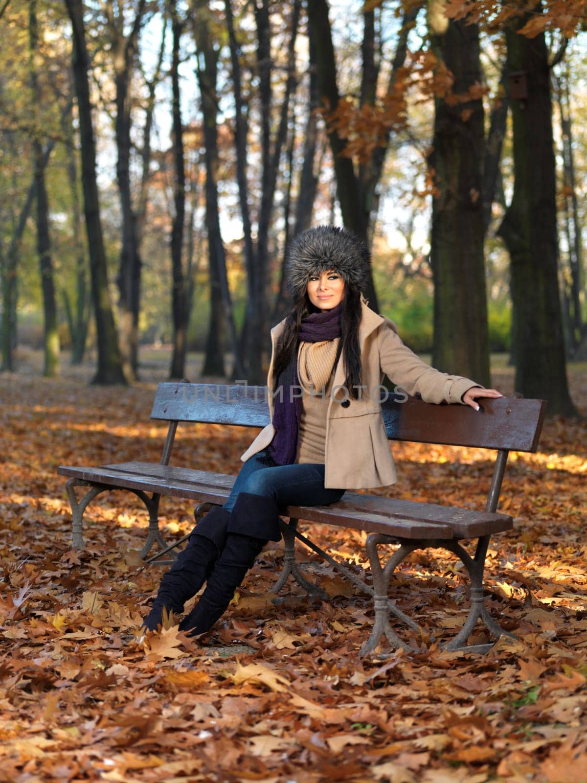 Beautiful woman spending time in park during autumn season