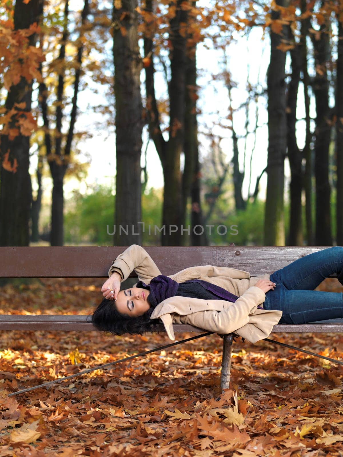 Beautiful woman spending time in park during autumn season