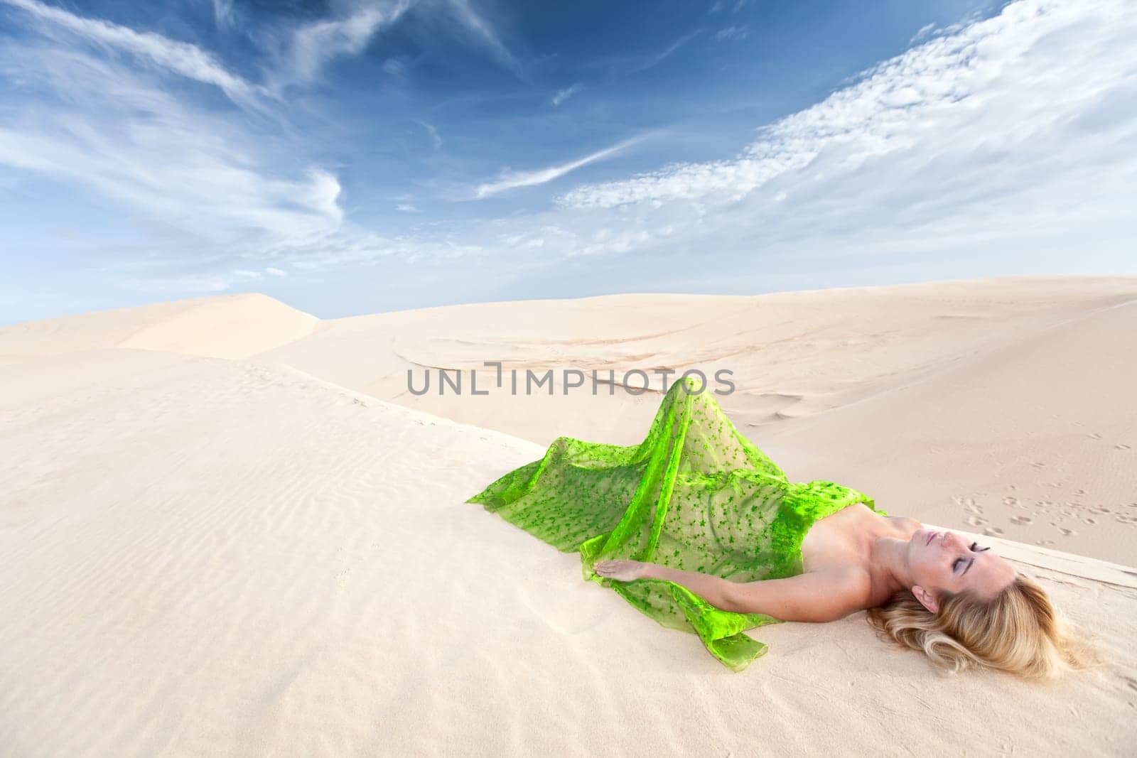 Beautiful woman sleeping in the middle of desert