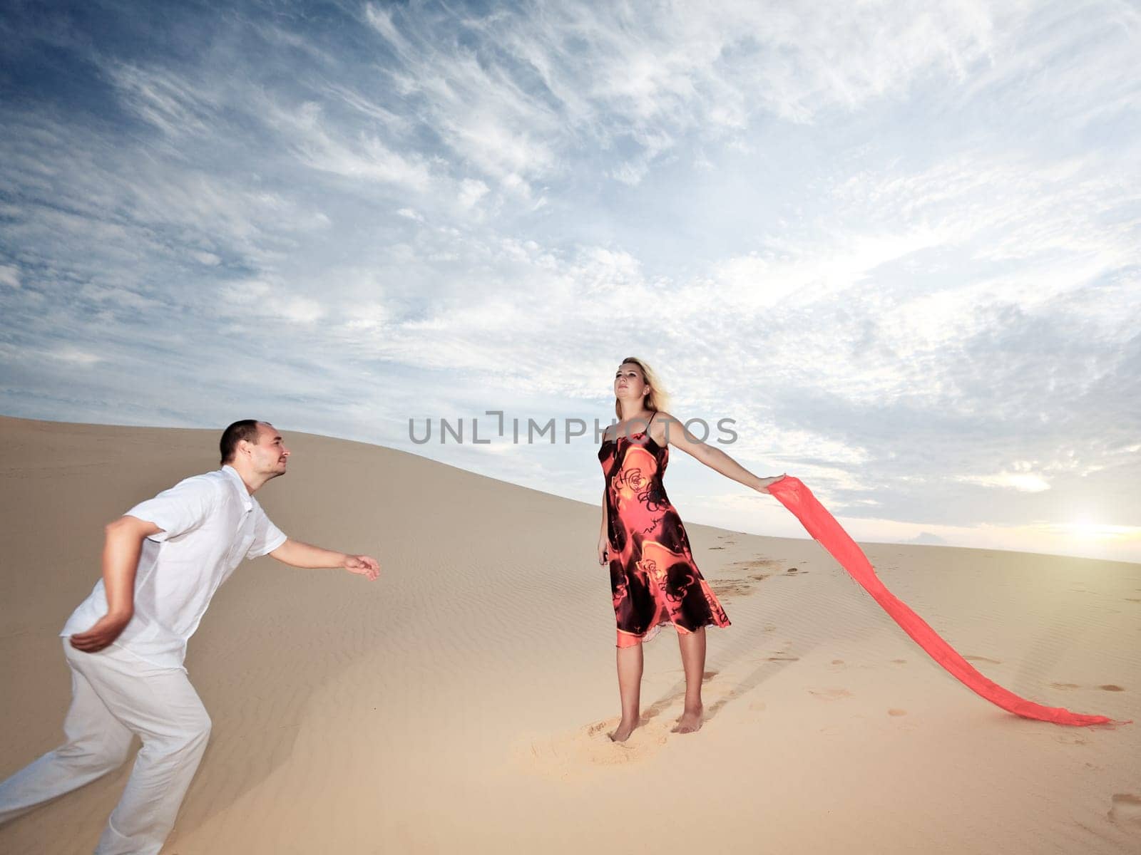 Man is running to loving girl in desert