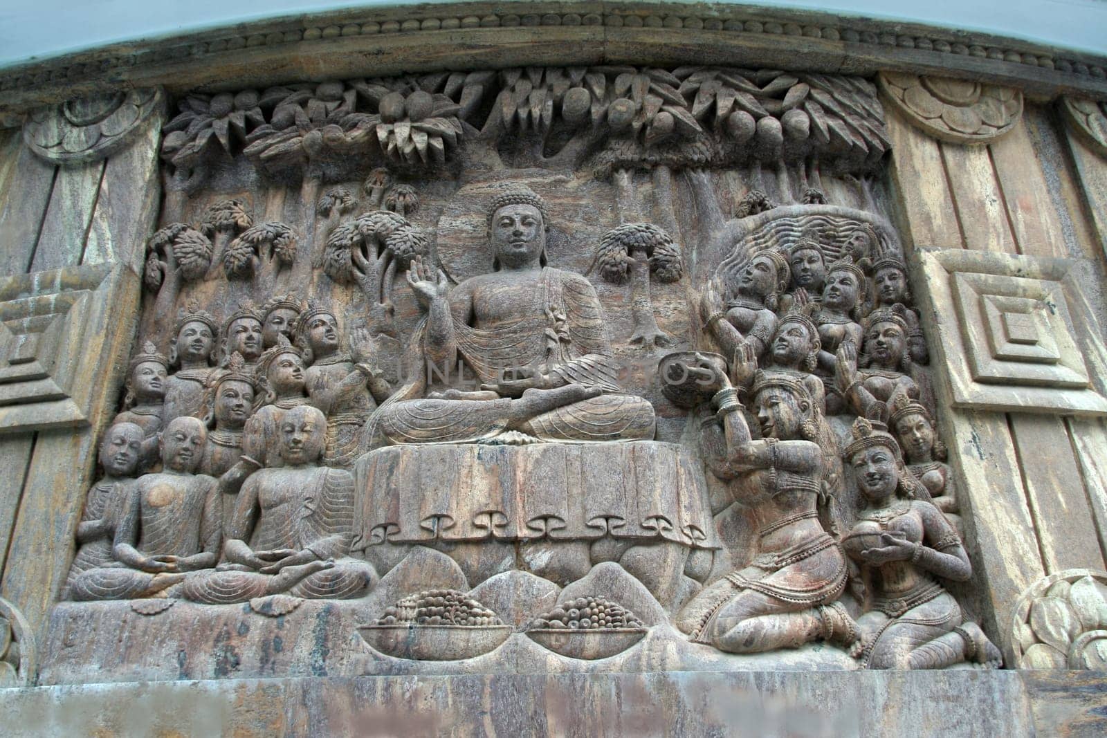Bas relief sculpture of Buddha in sermon at stupa in Darjeeling, India, Asia