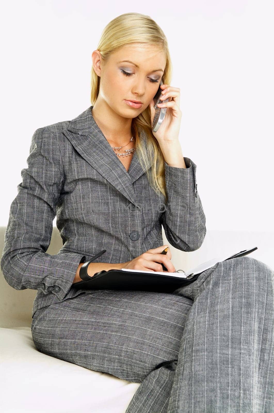 Young business woman talking by phone