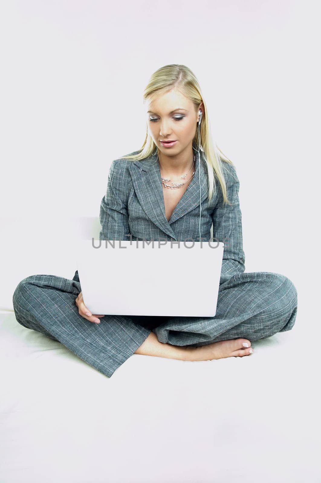 Portrait of a businesswoman working on laptop computer and listen to music