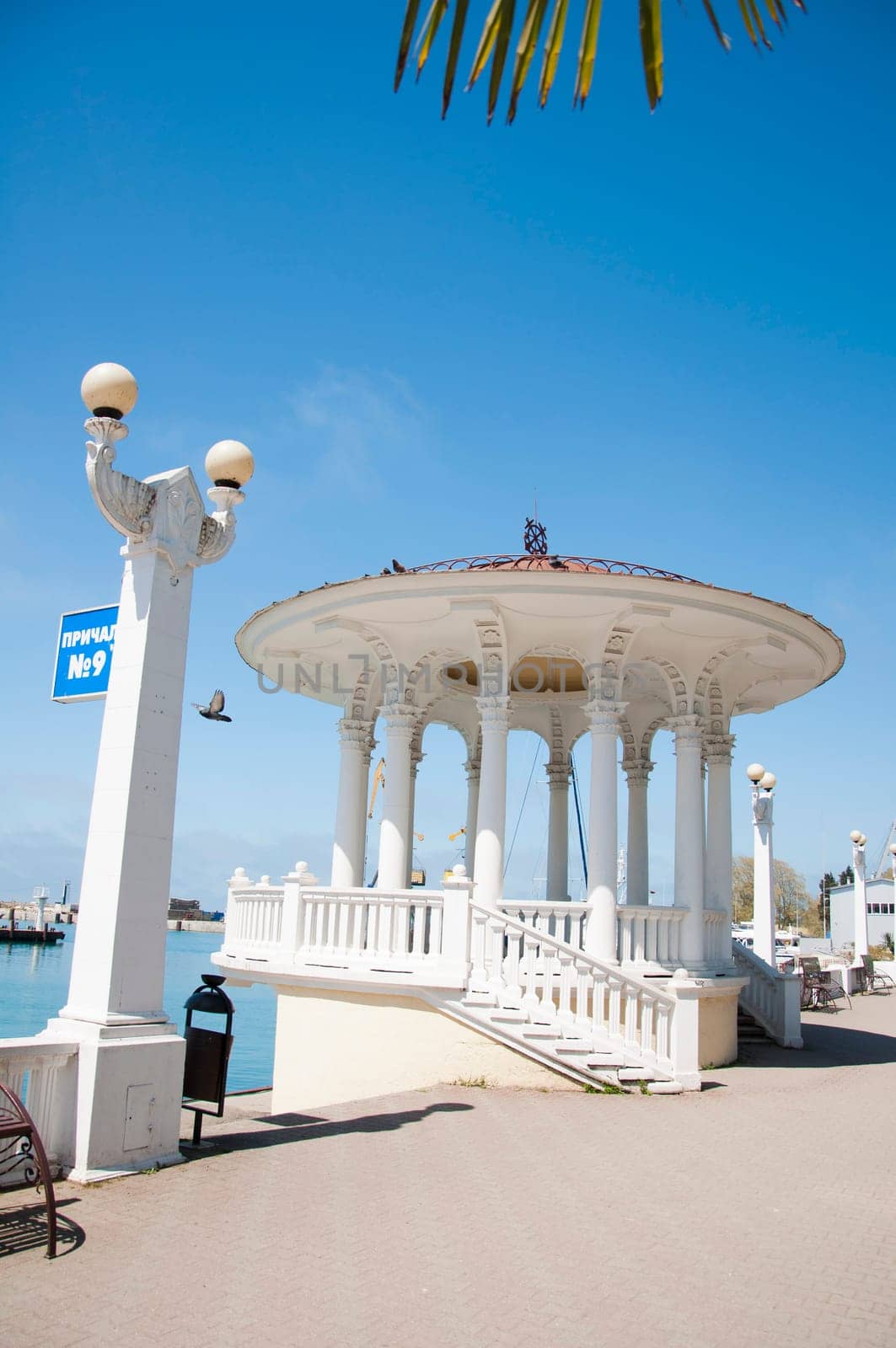 The white concrete gazebo in marine near the sea