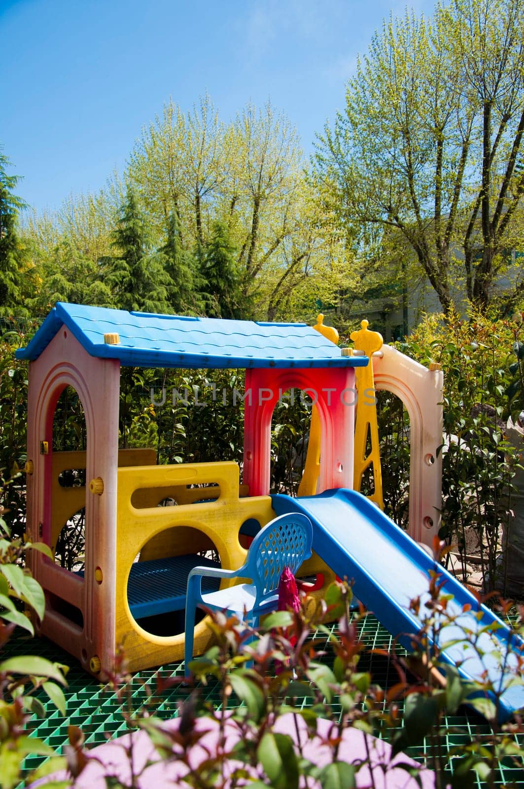an elevated view of slides and swings in the park