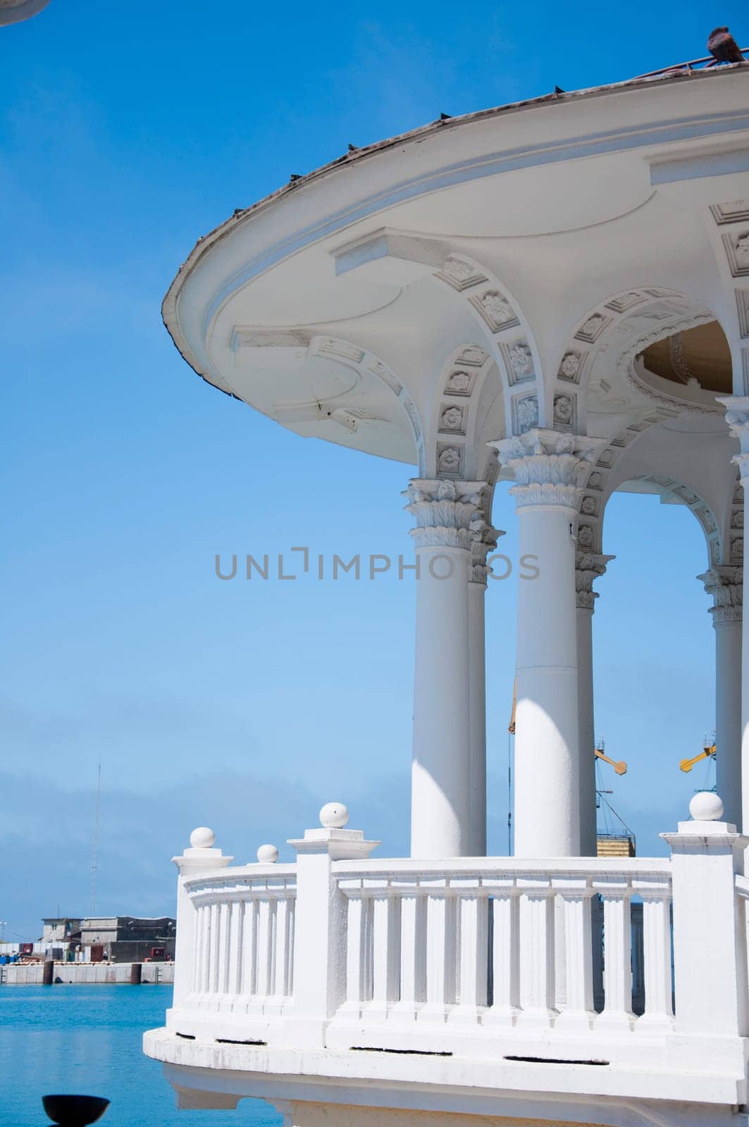 The white concrete gazebo in marine near the sea