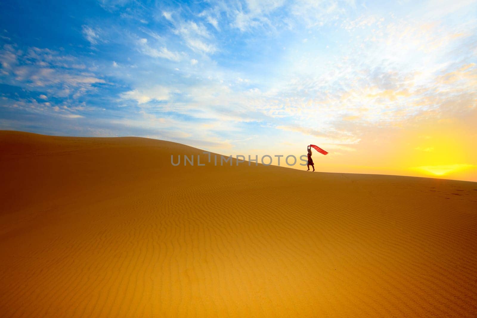 Beautiful woman with red showl in desert