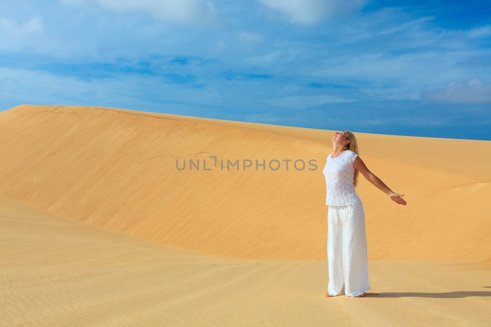 Beautiful woman with opened nahds in desert