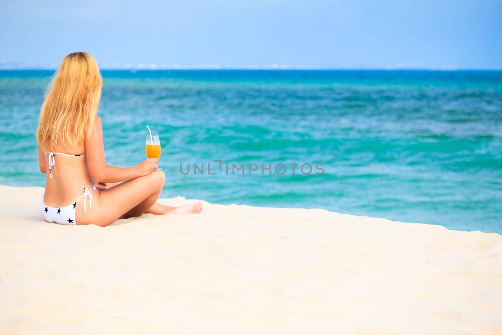 Wiman with juice on the tropical beach