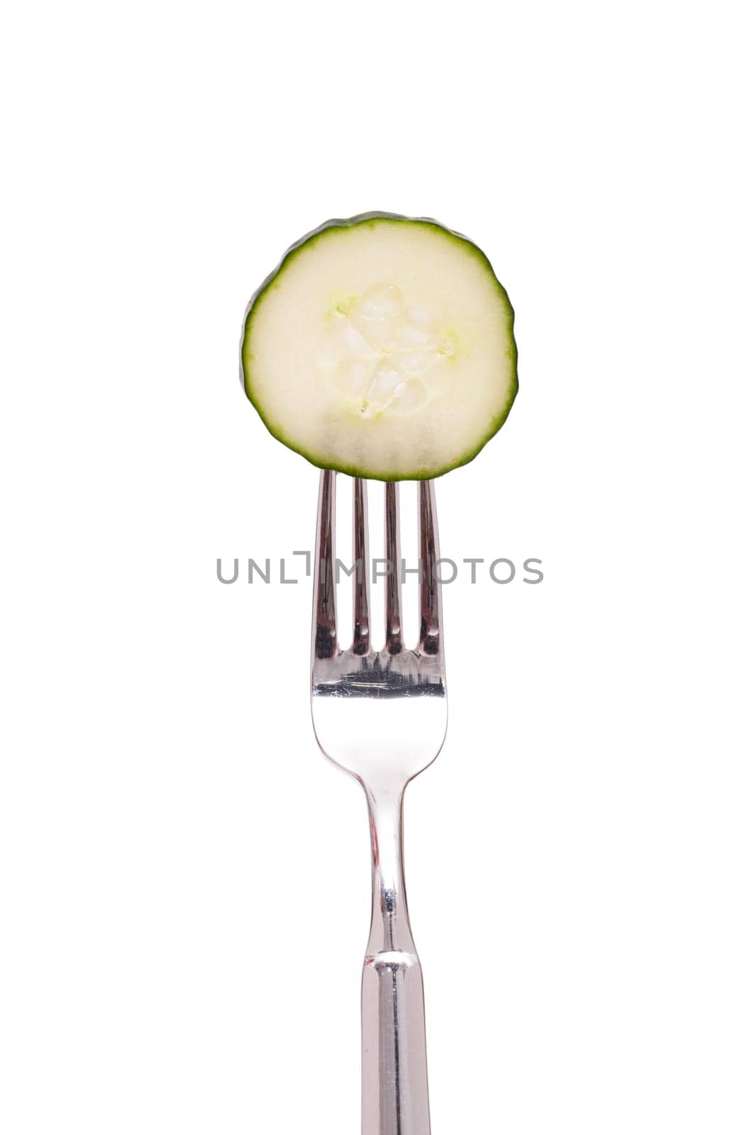 White cut-out slice of cucumber on a fork